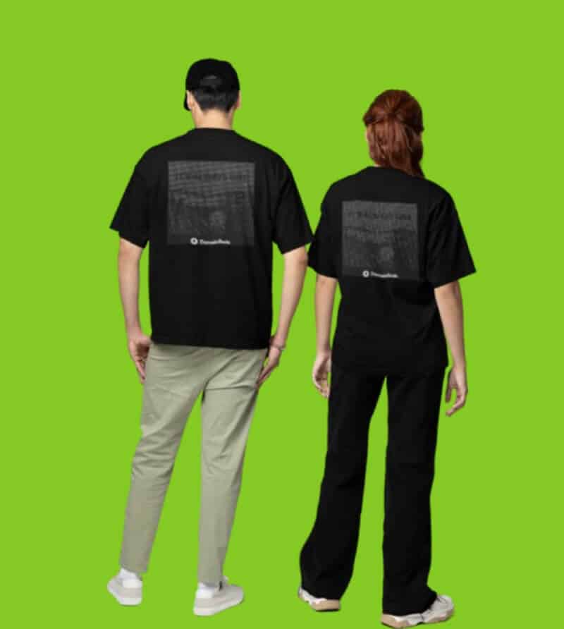 Man and woman standing, showing their backs, while wearing RSA t-shirt merchandise against a green background
