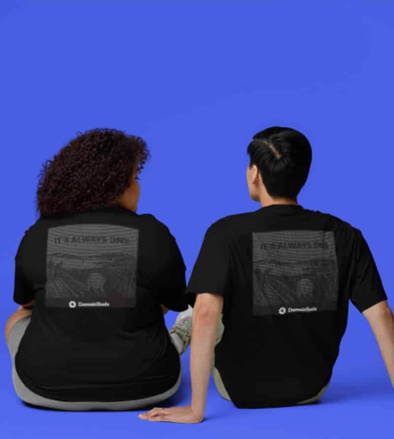 Man and woman sitting, showing their backs, while wearing RSA t-shirt merchandise against a blue background