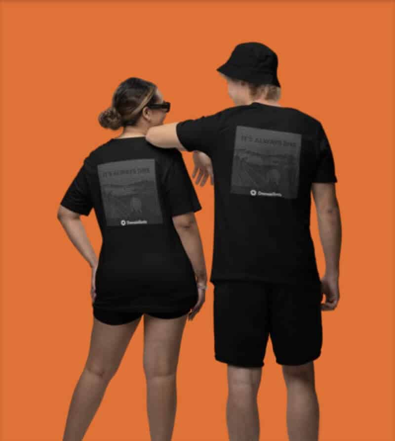 Man and woman standing, showing their backs, while wearing RSA t-shirt and bucket hat merchandise against an orange background