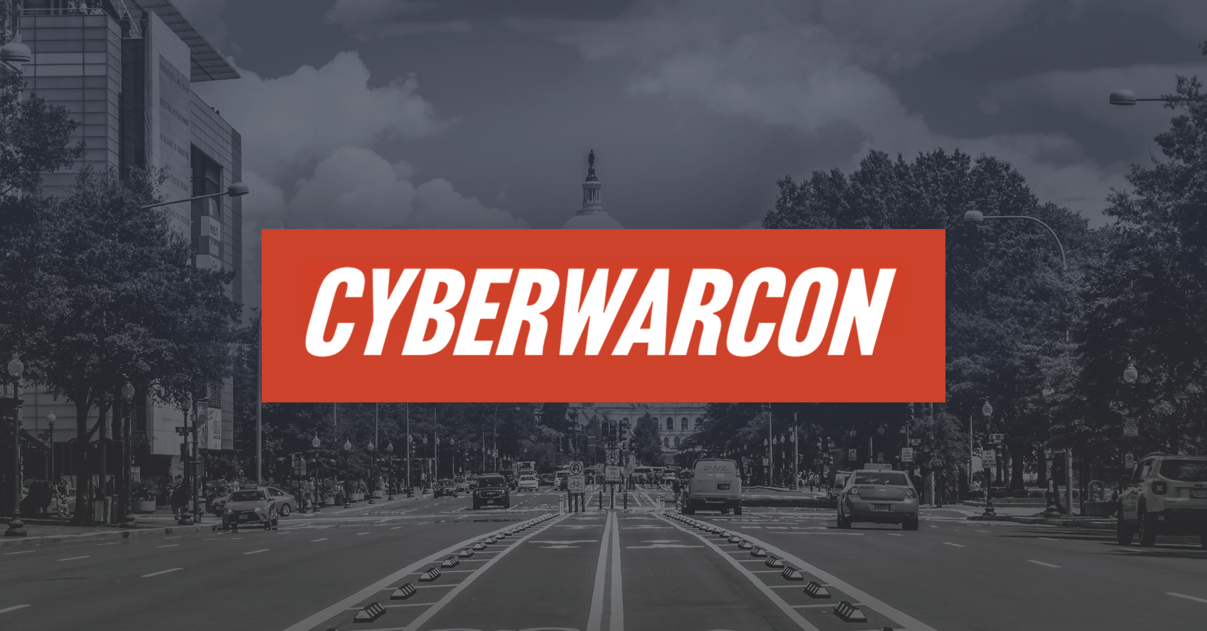 A city street with cars and trees, leading toward a domed building in the background. The word "CYBERWARCON" is boldly displayed in white letters on a red rectangle across the center.