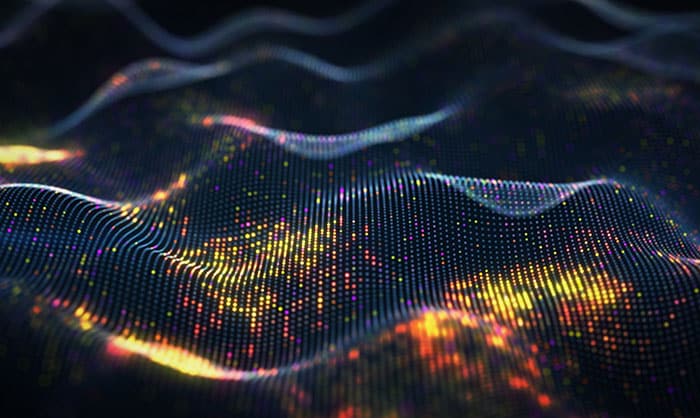 Abstract digital wave of glowing particles. the pattern resembles a dynamic flow of data or sound across a dark background, highlighted by vibrant colors mainly in orange and yellow tones.