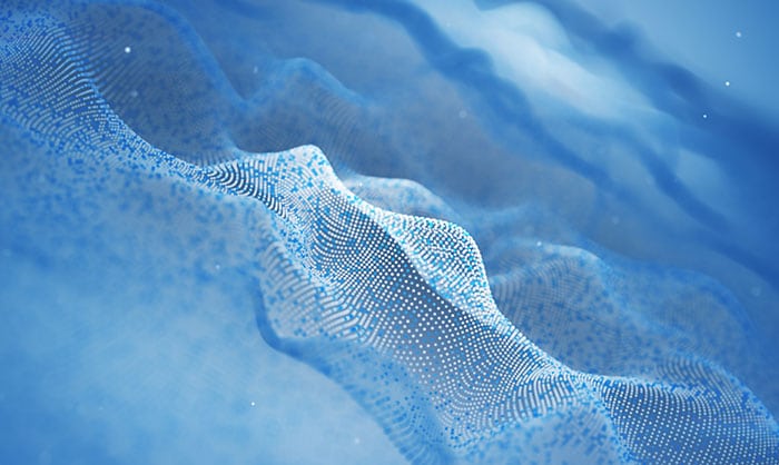 Abstract digital image depicting waves made of blue dots, creating a sense of flowing water through a grid of illuminated particles carrying arbitrary data payloads against a blurred background.