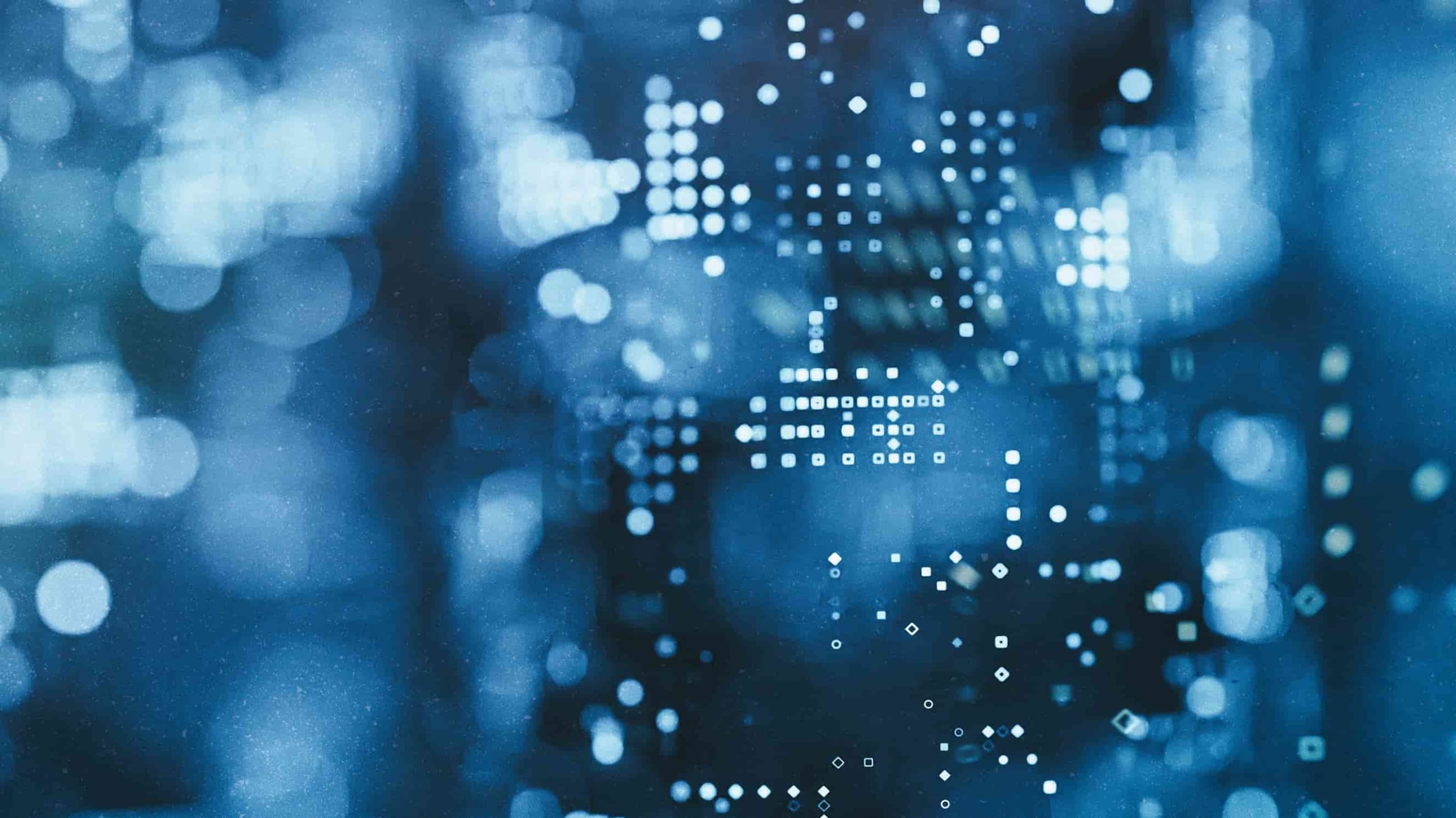 An abstract image showing blurred blue lights with white digital binary code overlay, creating a futuristic, technology-themed background.