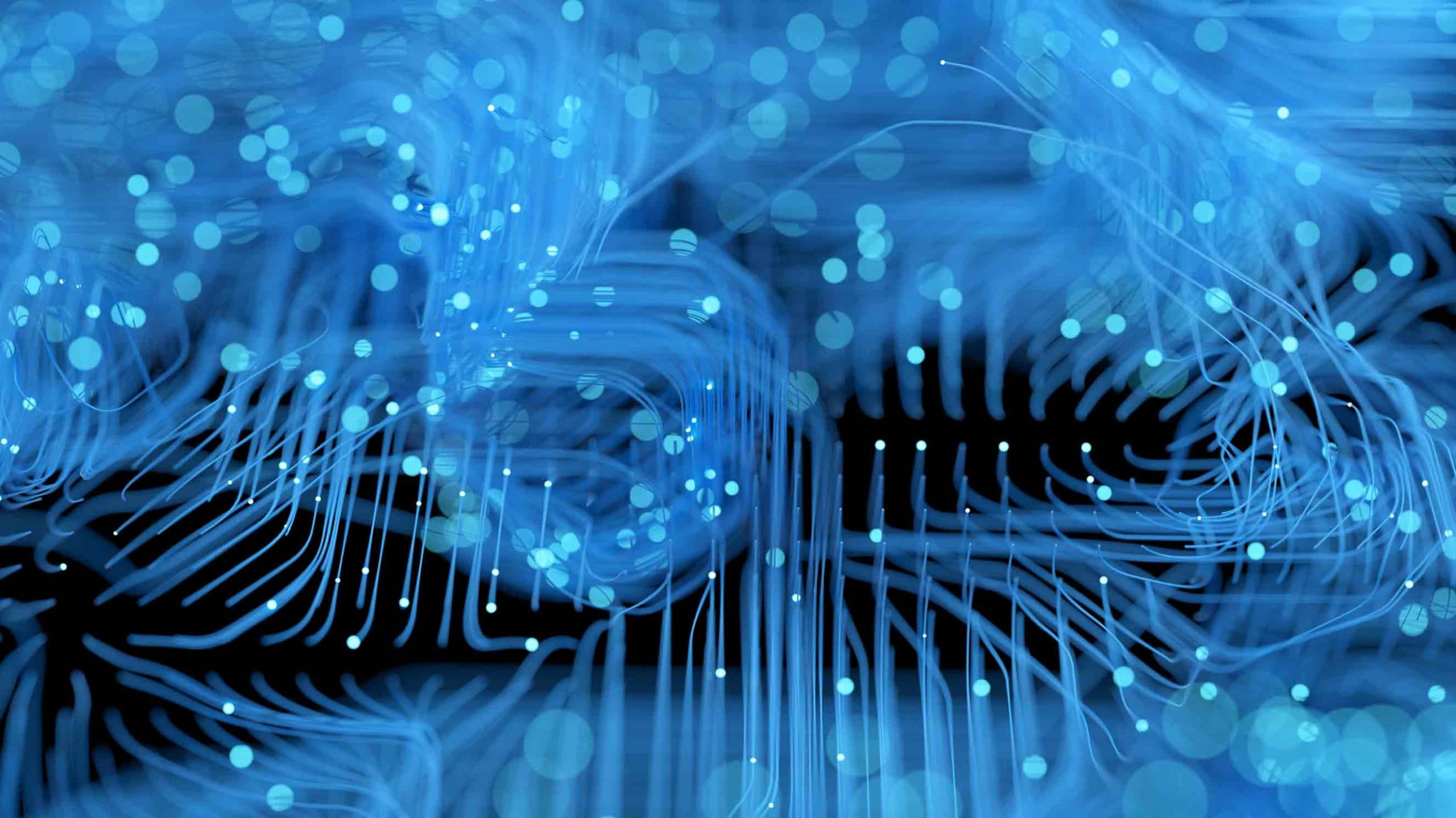 Abstract digital artwork with swirling blue light patterns and glowing dots on a dark background, conveying a sense of electronic circuitry or data flow.