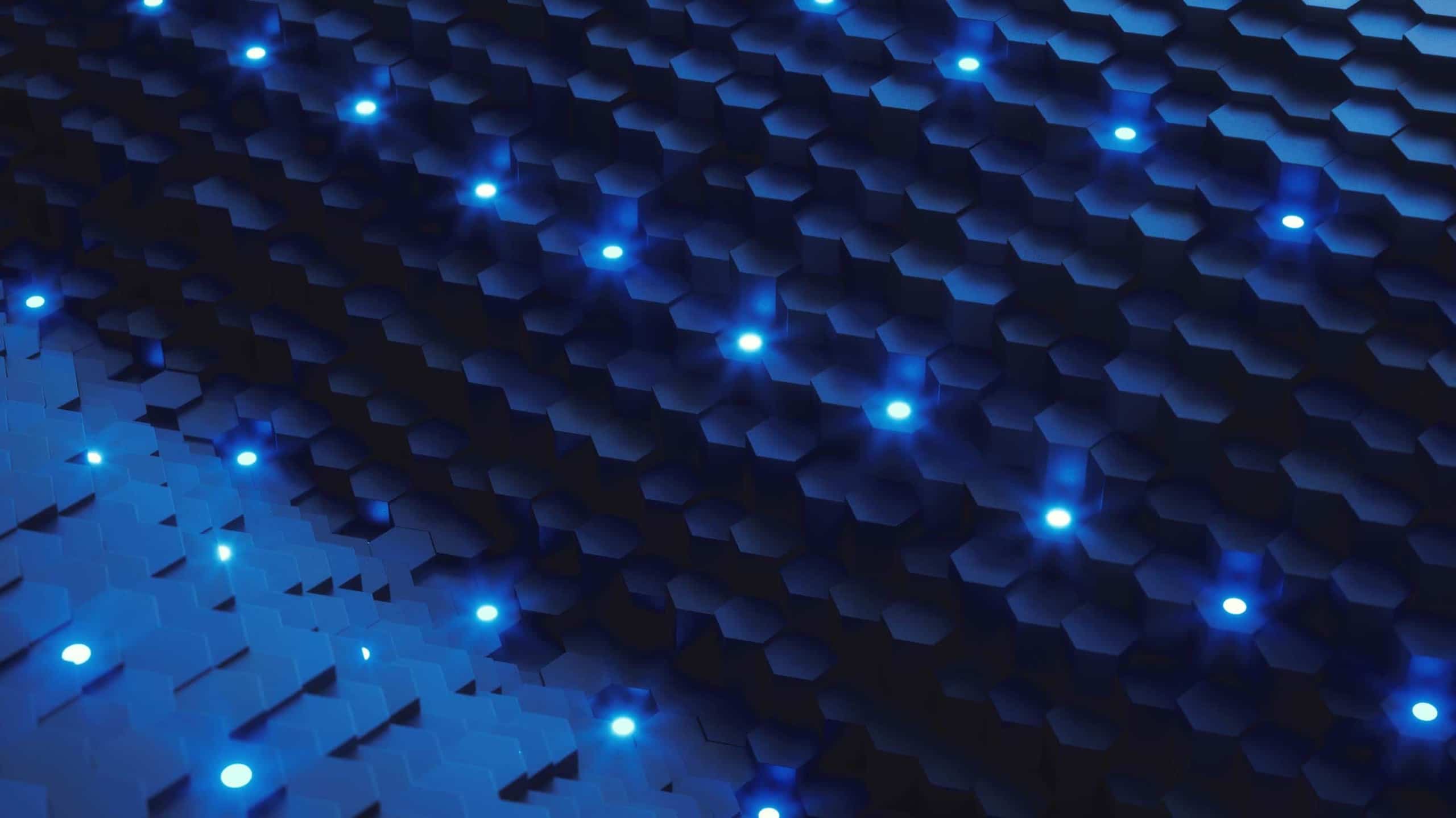 Abstract pattern of hexagonal shapes in shades of blue with glowing blue lights scattered throughout, creating a futuristic, geometric background.
