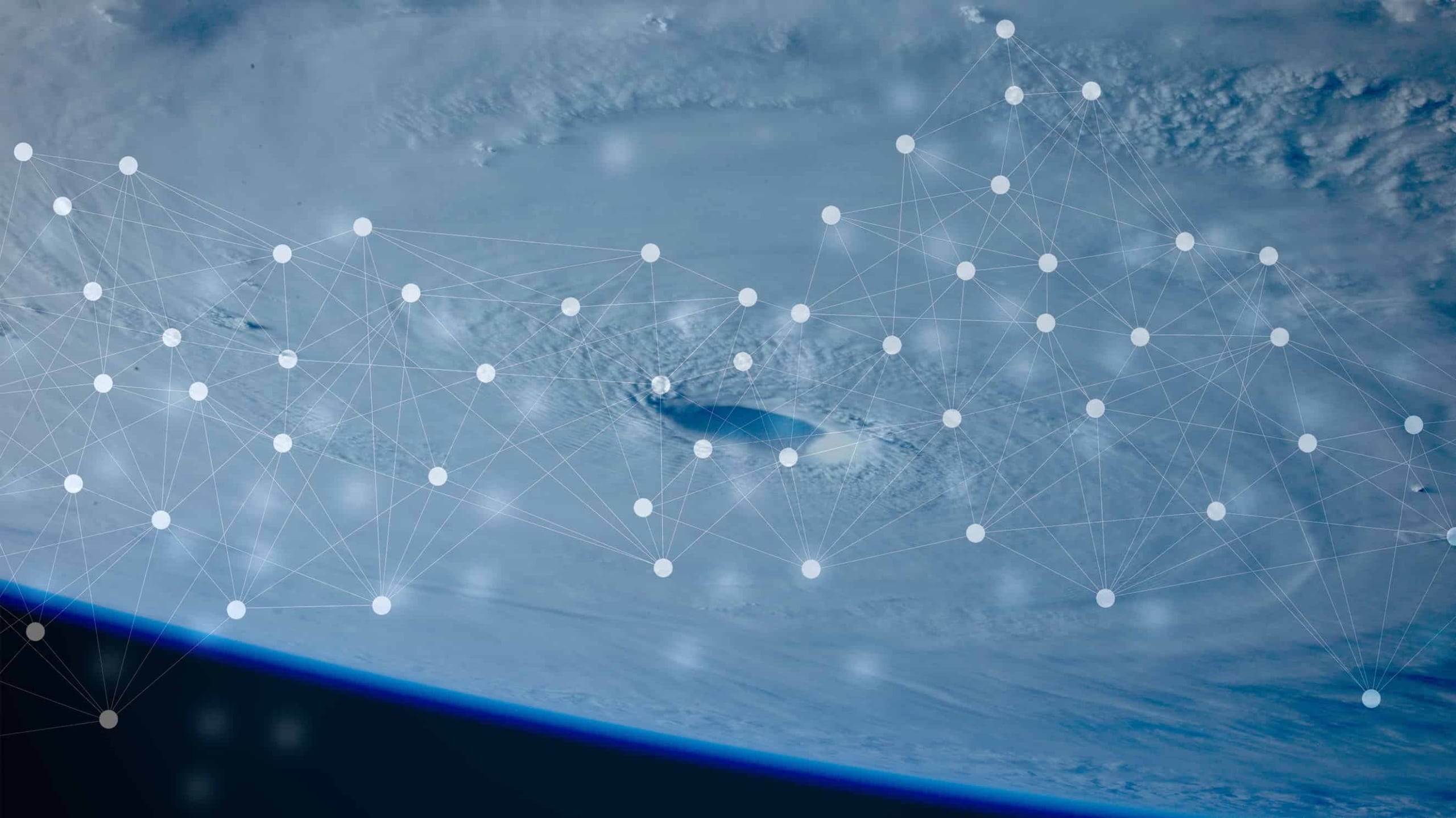 An abstract image featuring a high-altitude view of earth with a detailed network of white lines and dots overlaying, suggesting data connectivity or a digital network concept.