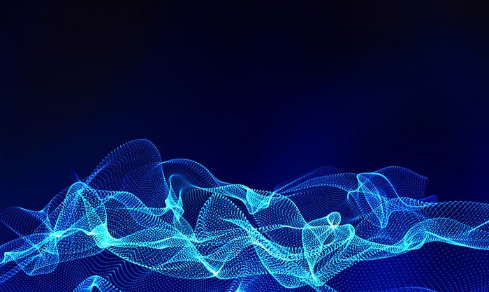Abstract digital wallpaper featuring dynamic blue wave patterns composed of luminous dots and lines on a dark blue background, creating a sense of fluid motion.