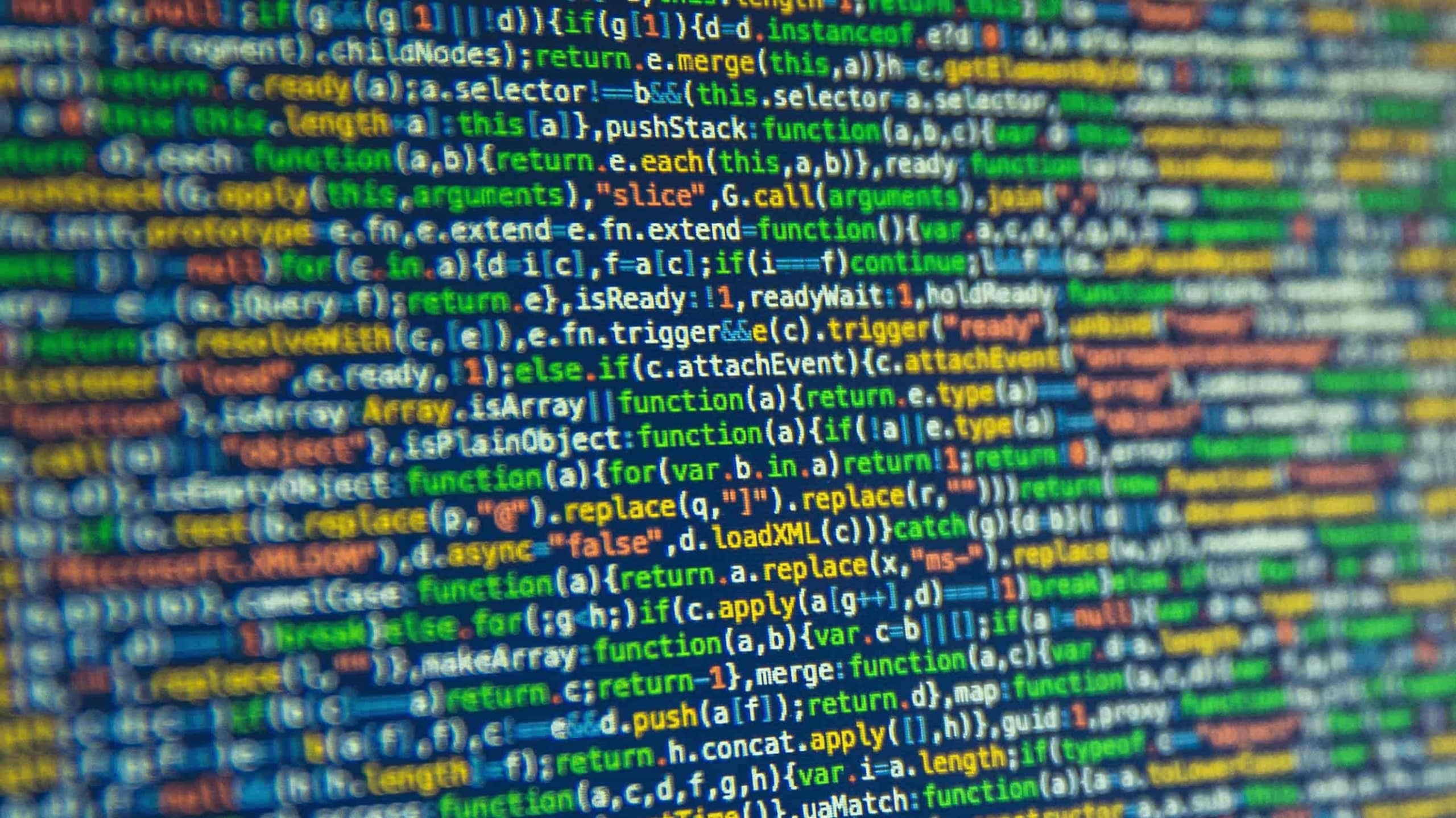 Close-up view of a computer screen displaying colorful programming code, with focus on central lines and blurred periphery, emphasizing the intricacy of software development.